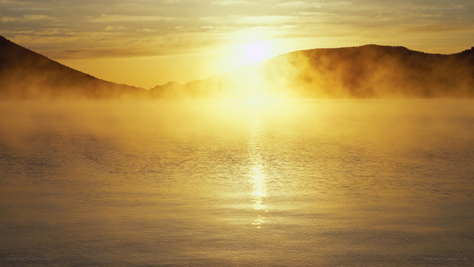 Sunrise over misty lake