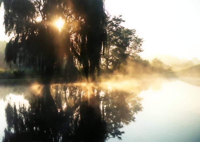 Sunrise over misty lake