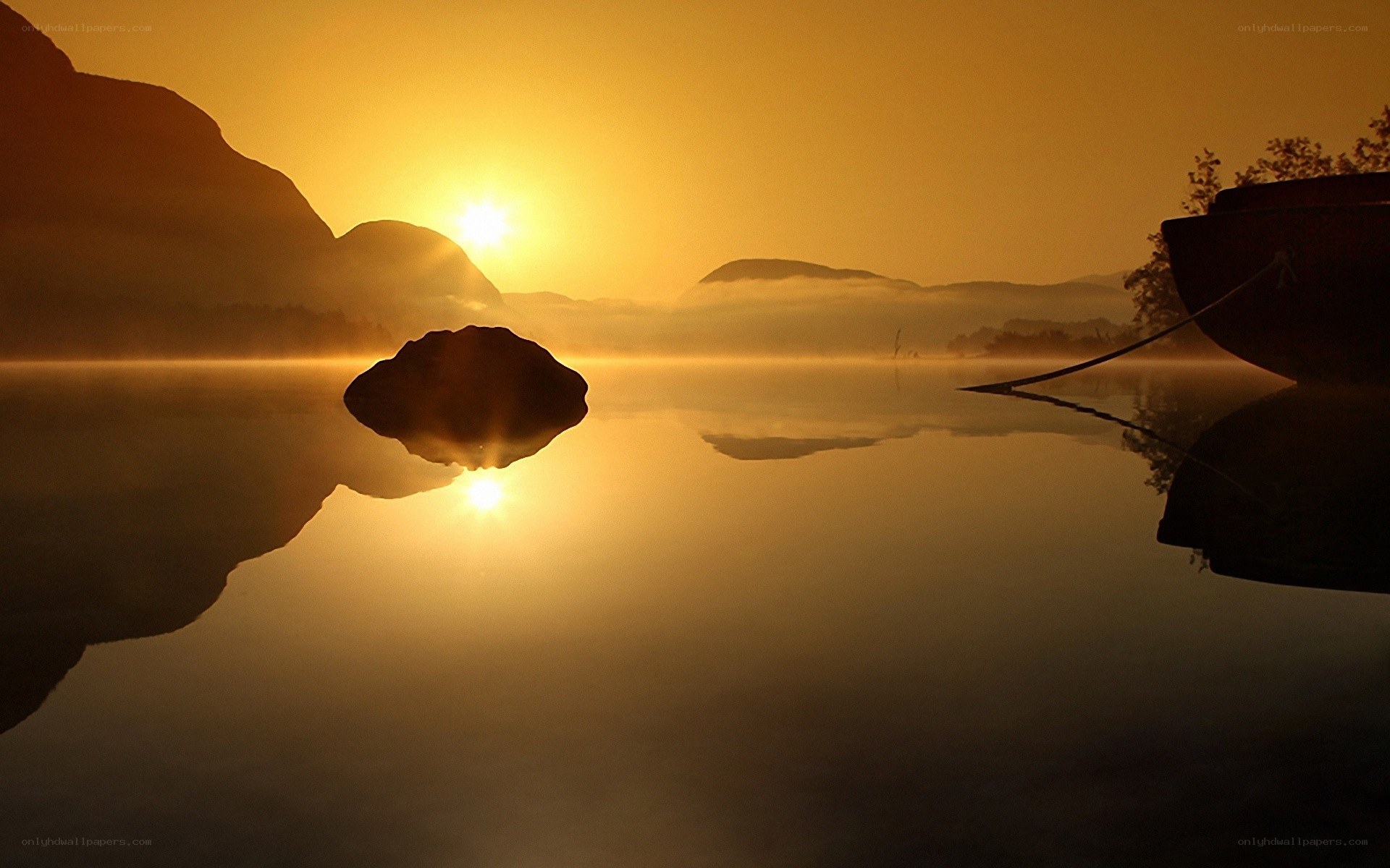Sunrise over misty lake