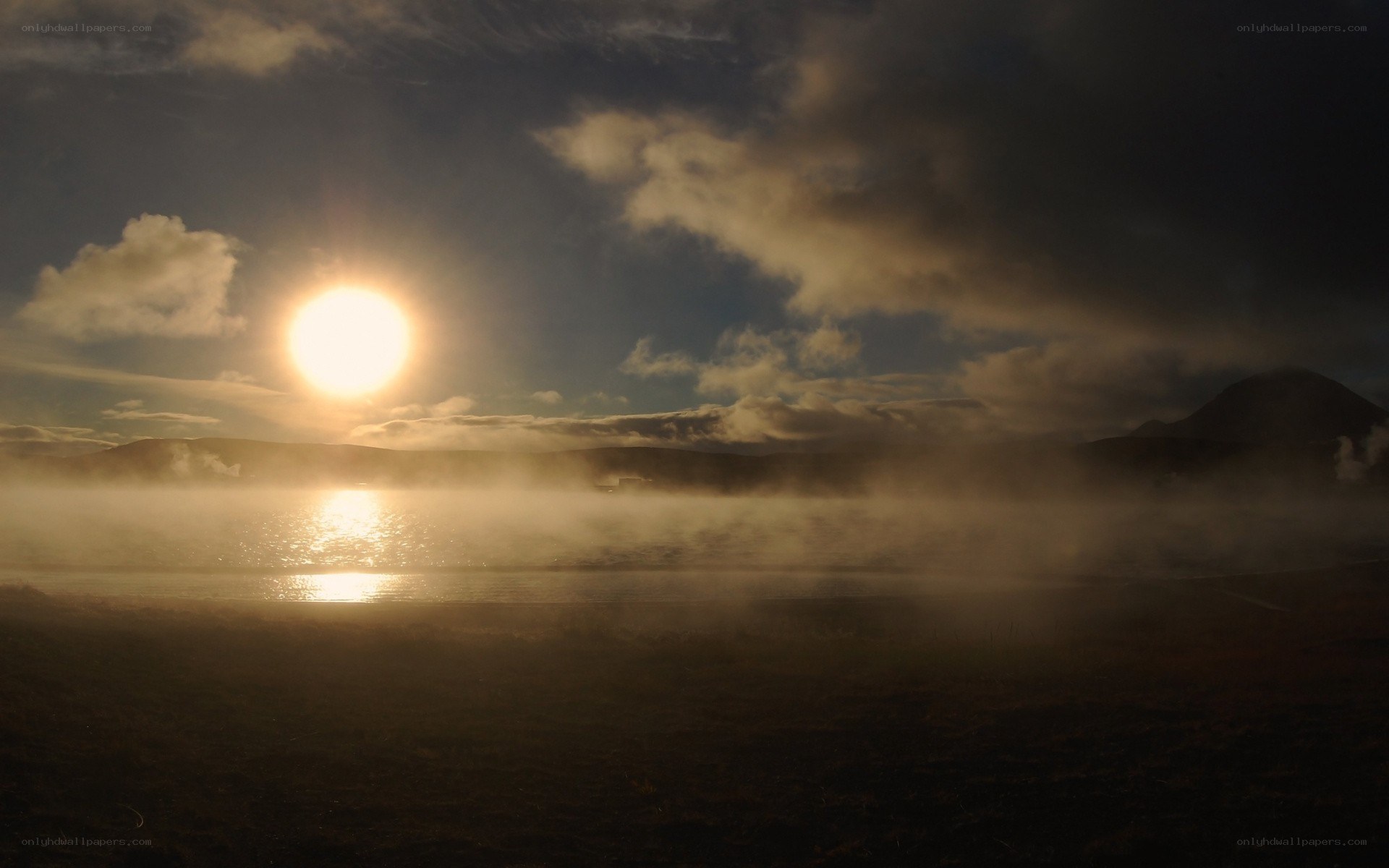 Sunrise over misty lake