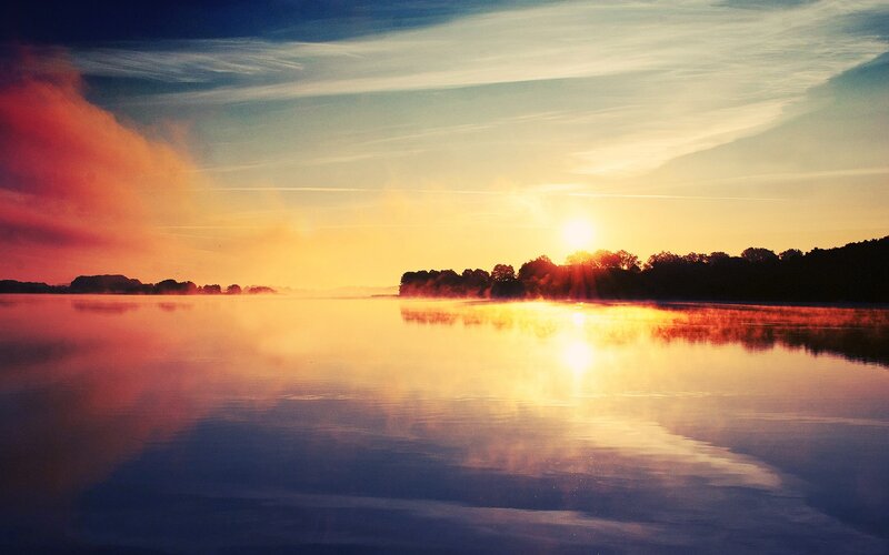 Sunrise over misty lake