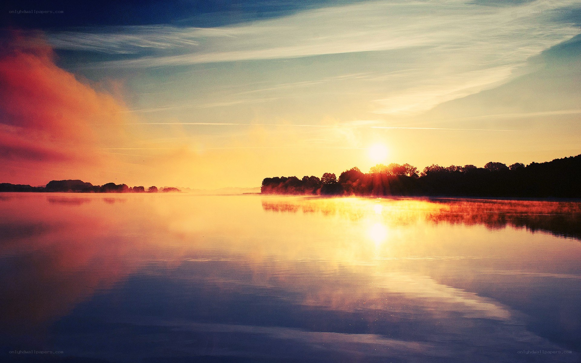 Sunrise over misty lake