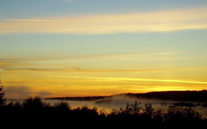 Sunrise over misty lake
