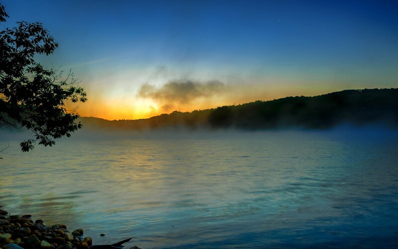 Sunrise over misty lake