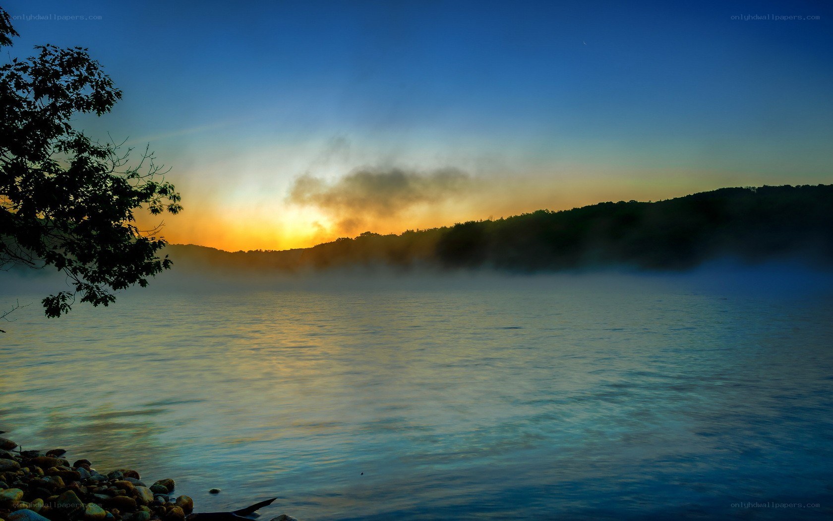 Sunrise over misty lake