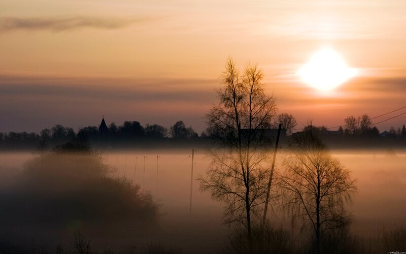 Sunrise over misty landscape