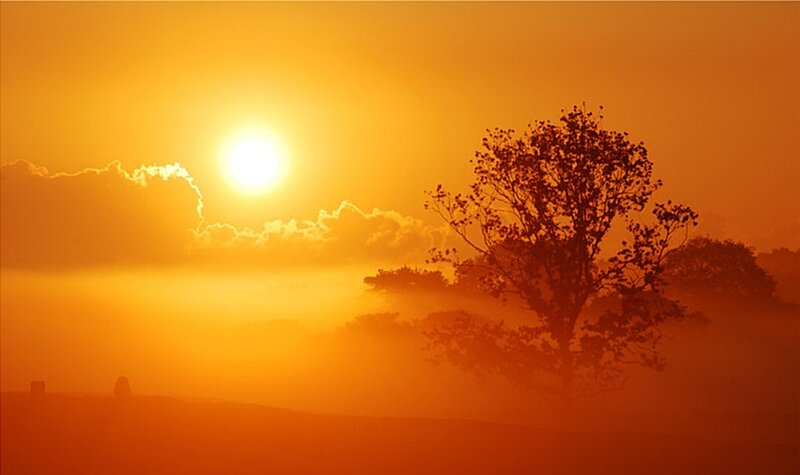Sunrise over misty landscape