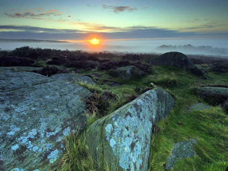 Sunrise over misty moorland