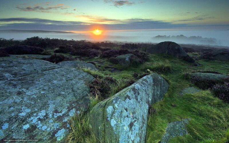 Sunrise over misty moorland