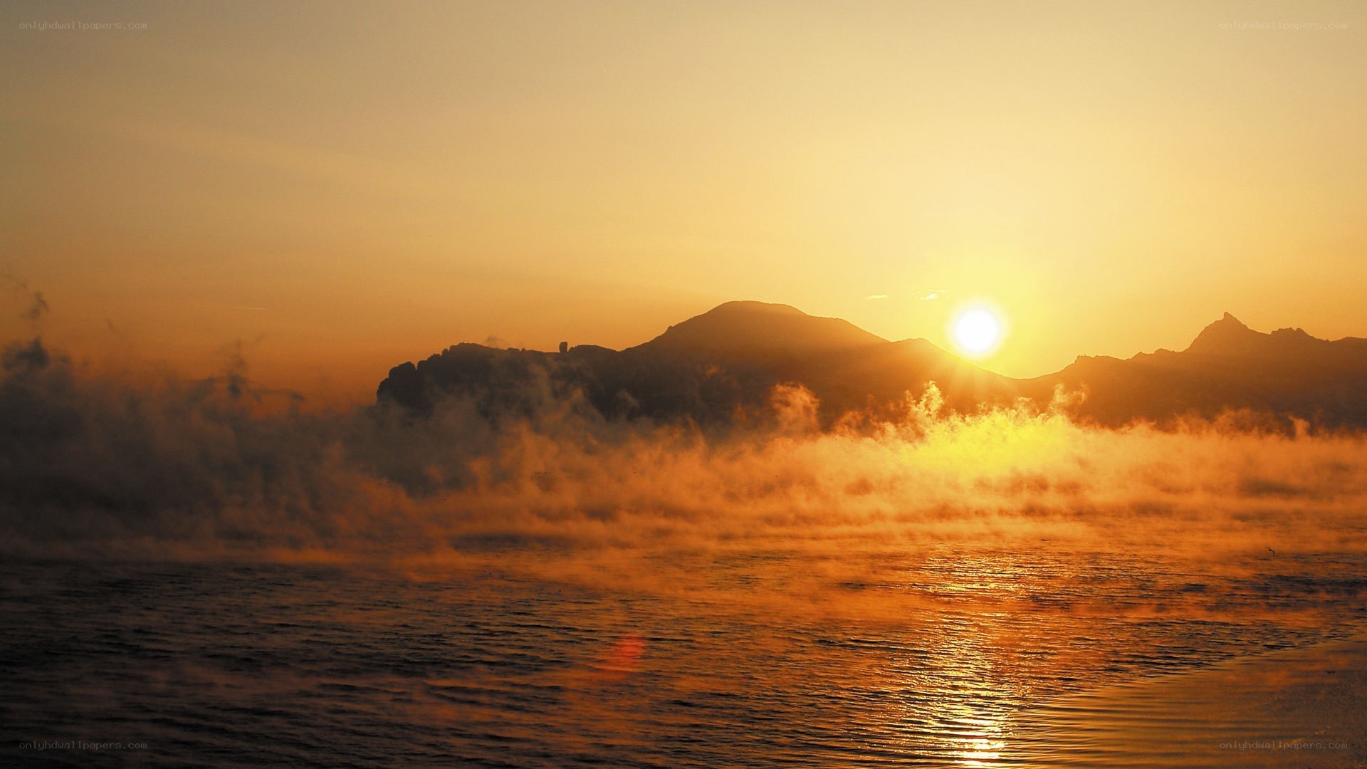 Sunrise over misty mountains