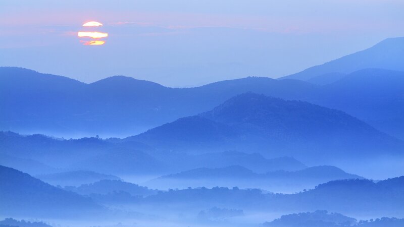 Sunrise over misty mountains