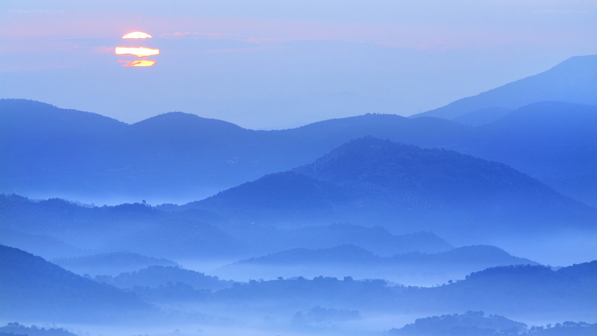 Sunrise over misty mountains