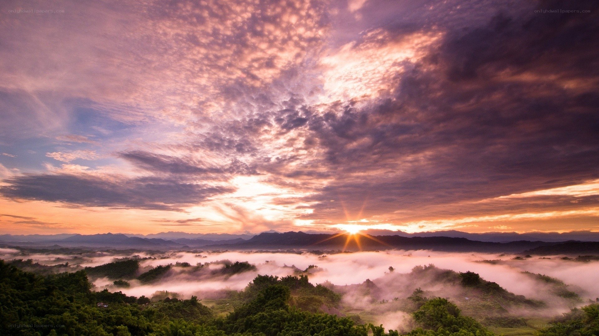 Sunrise over misty mountains
