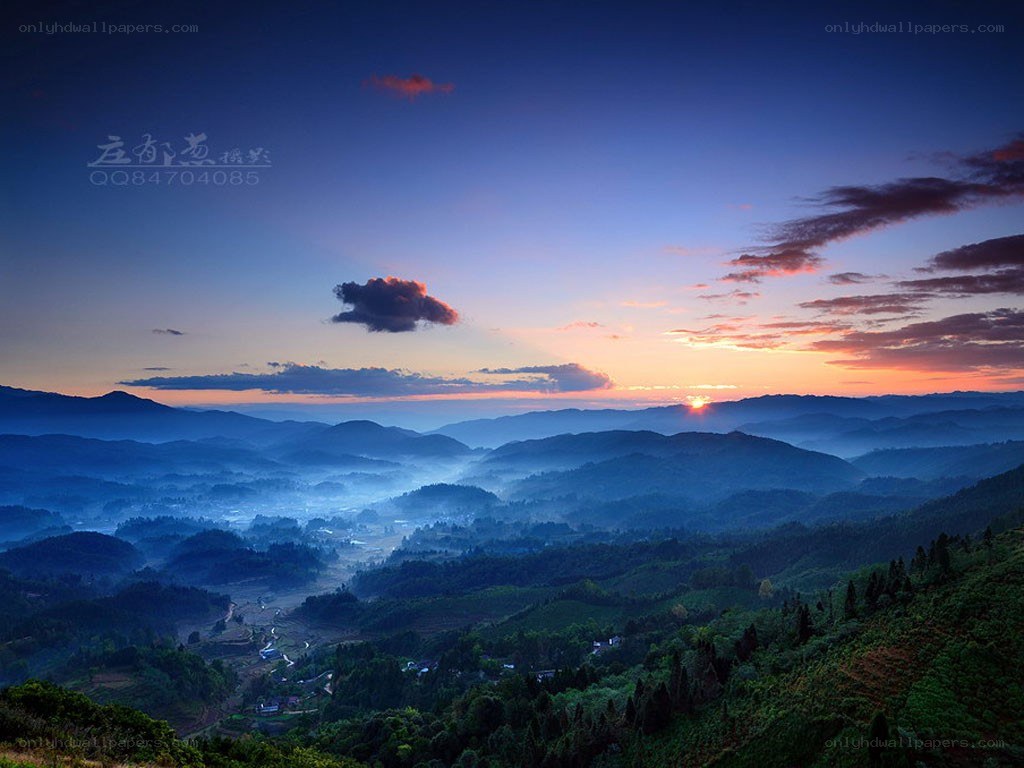 Sunrise over misty mountains