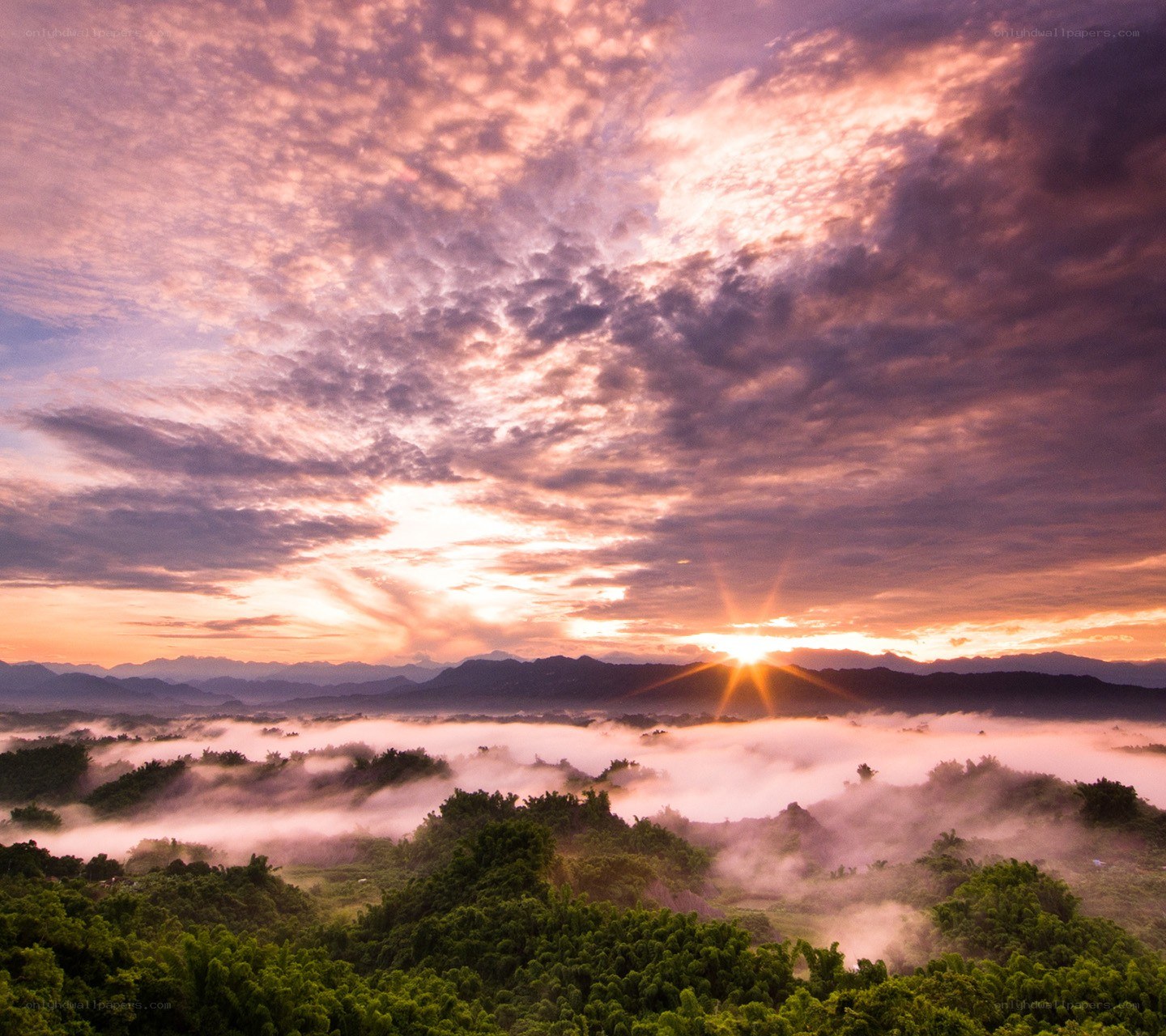 Sunrise over misty mountains