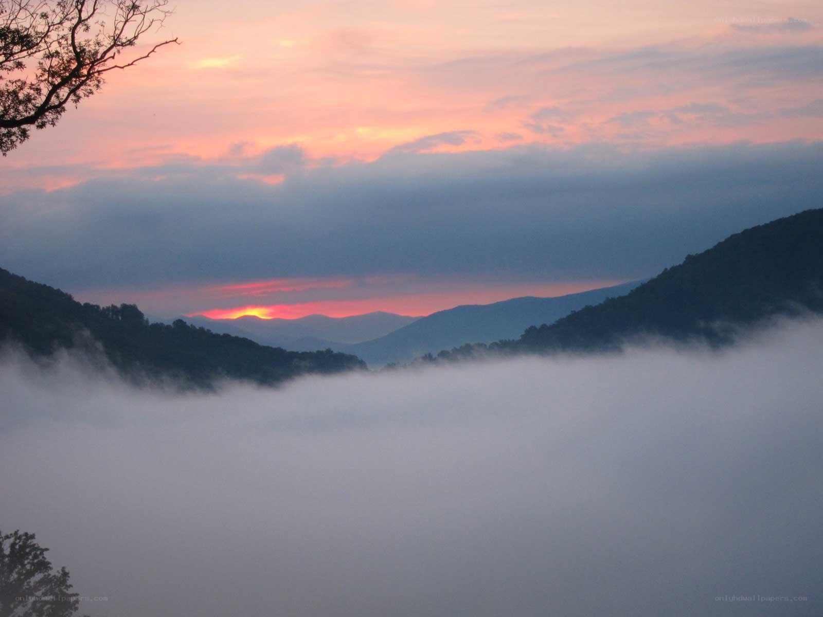 Sunrise over misty mountains