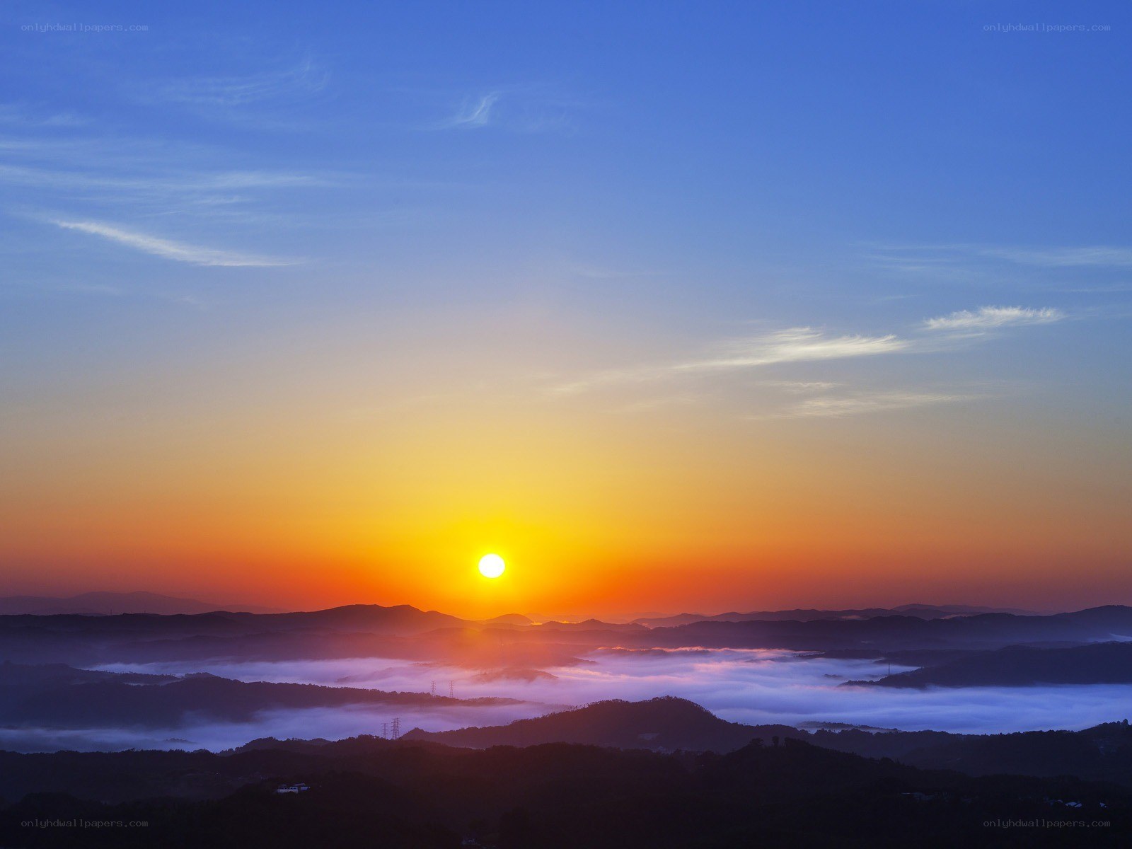 Sunrise over misty mountains
