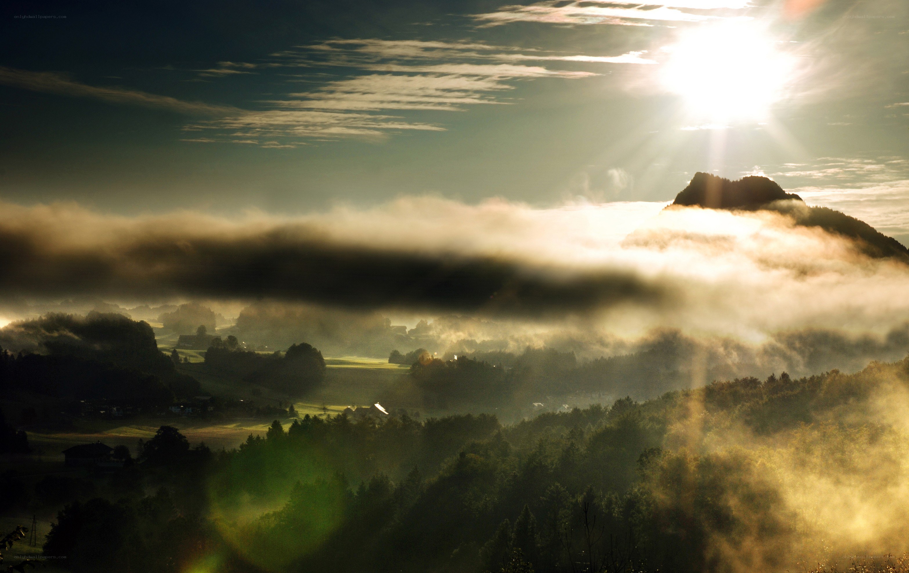 Sunrise over misty mountains