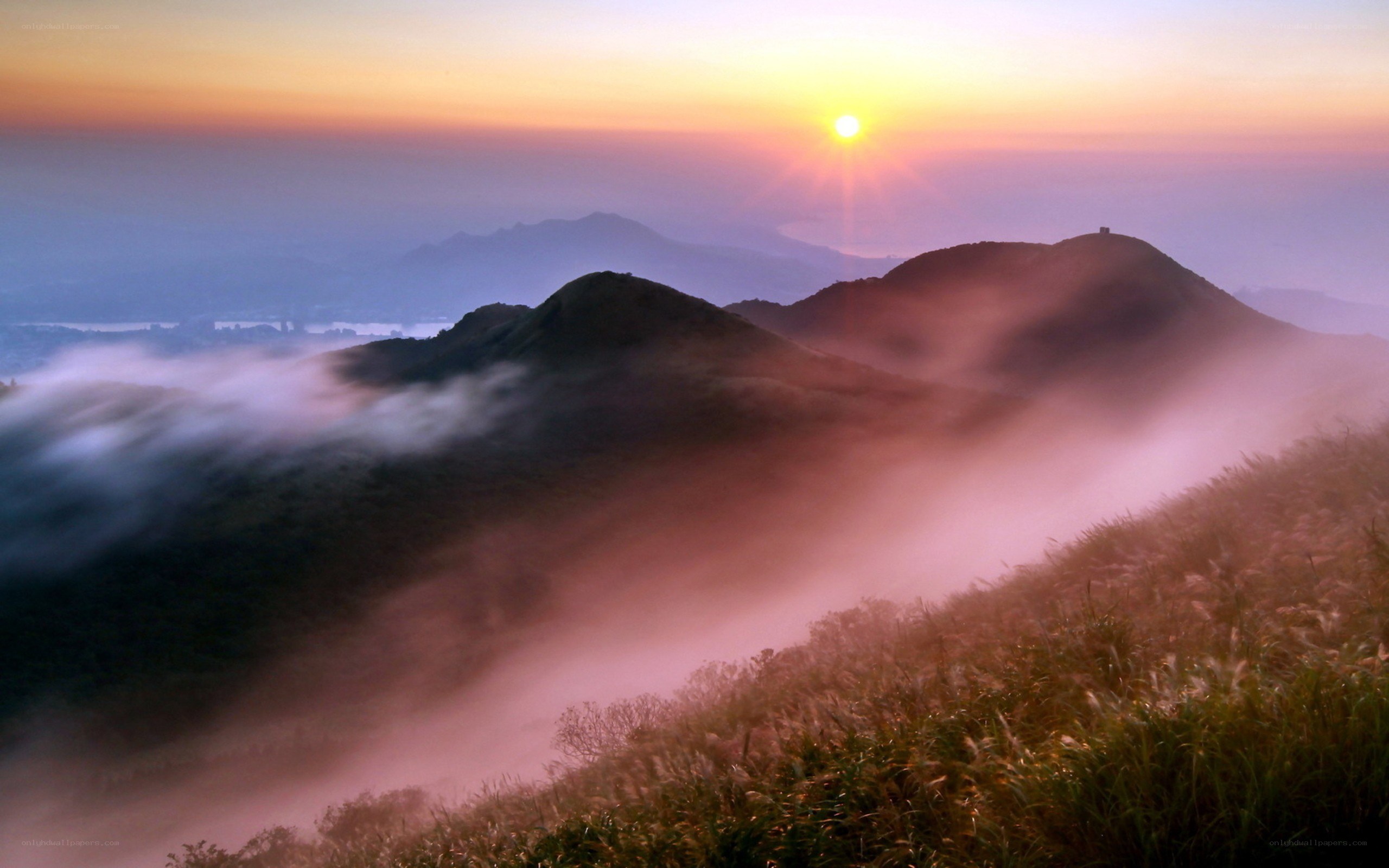 Sunrise over misty mountains
