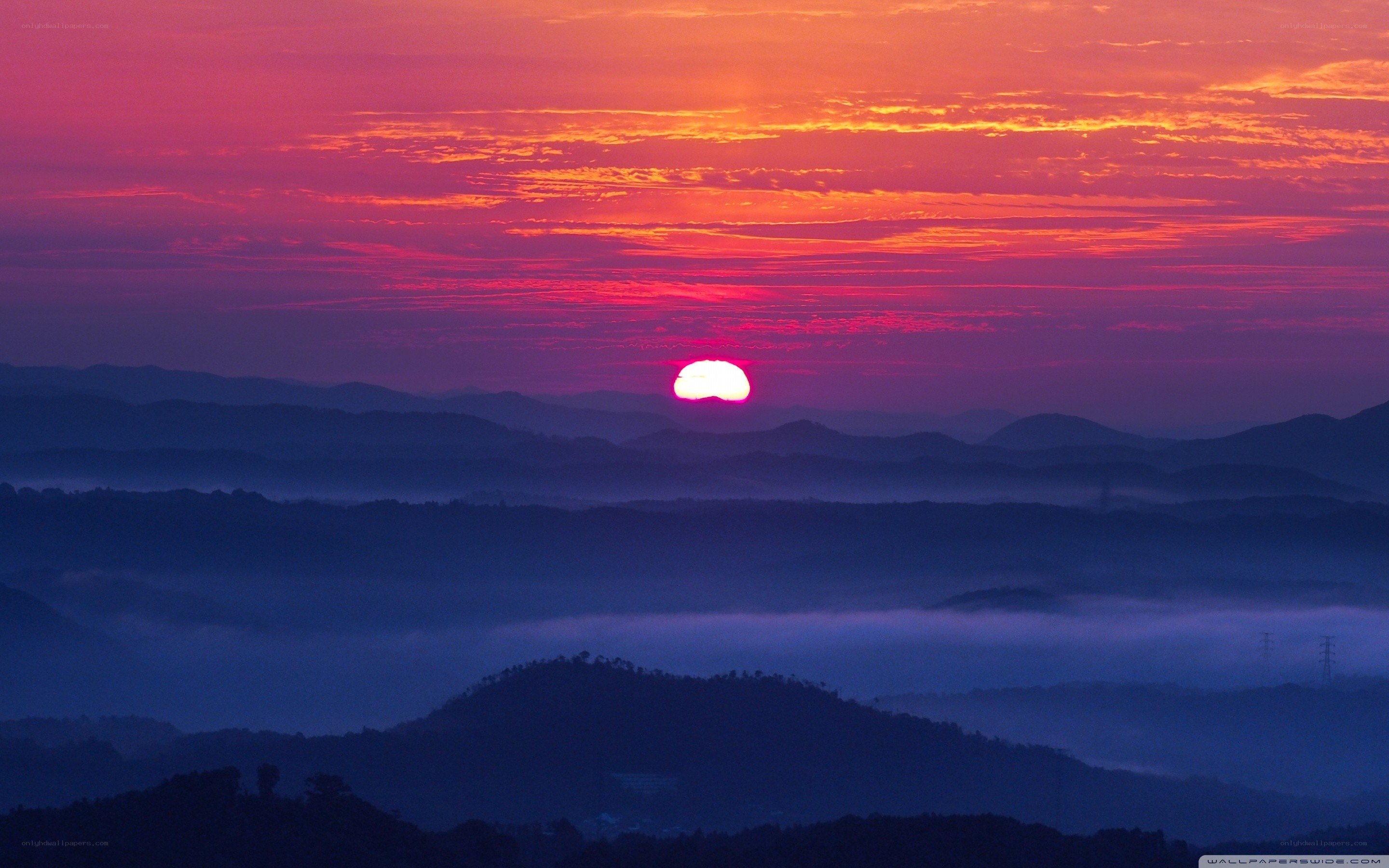 Sunrise over misty mountains