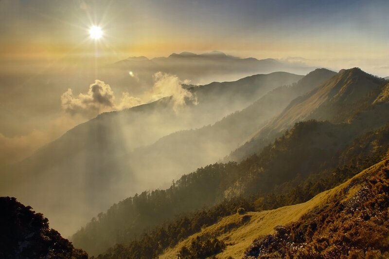 Sunrise over misty mountains