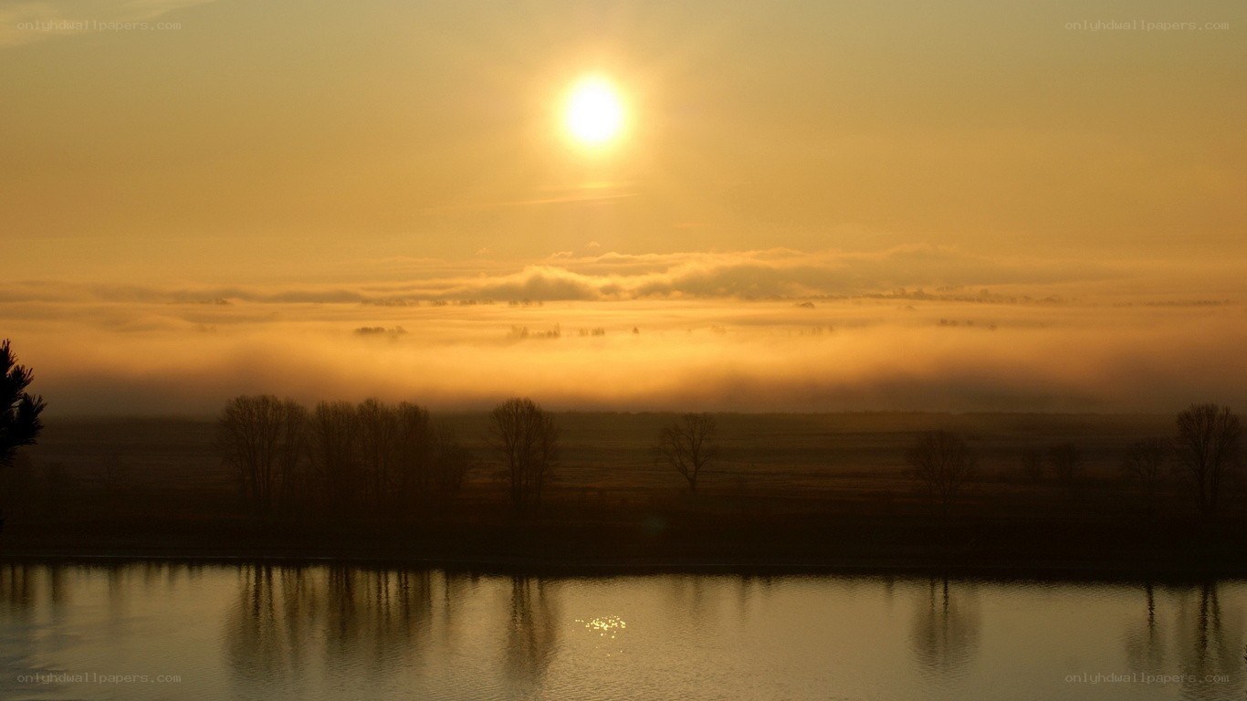 Sunrise over misty river