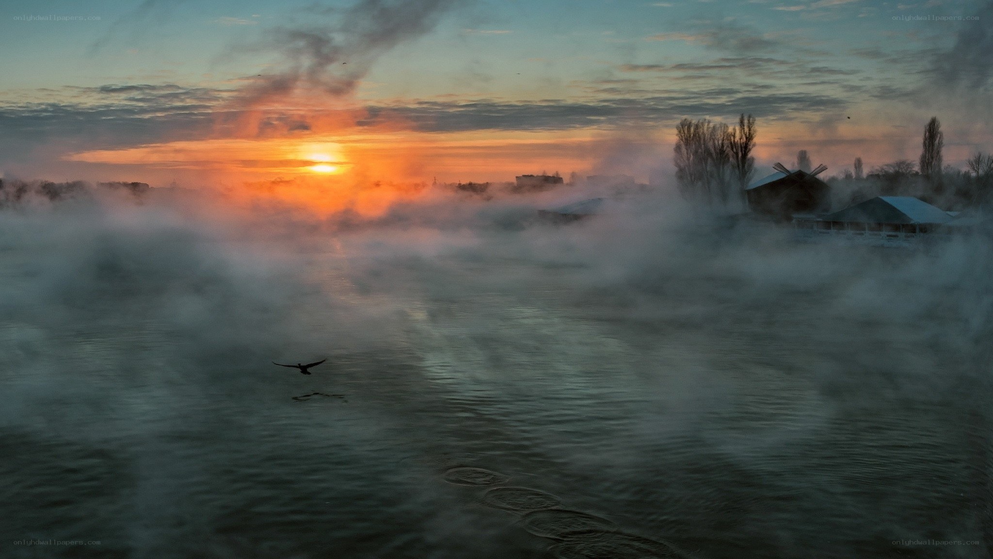 Sunrise over misty river