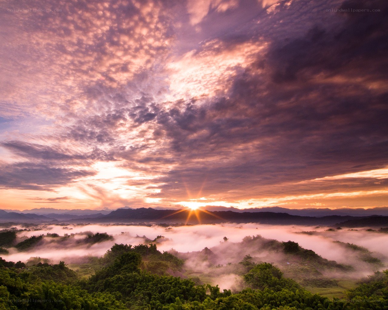 Sunrise over misty valley