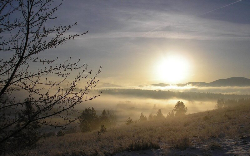 Sunrise over misty valley