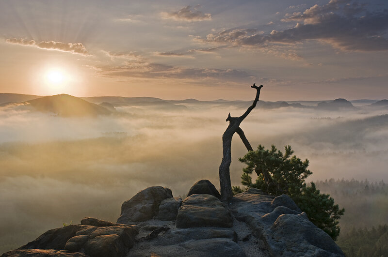 Sunrise over misty valley