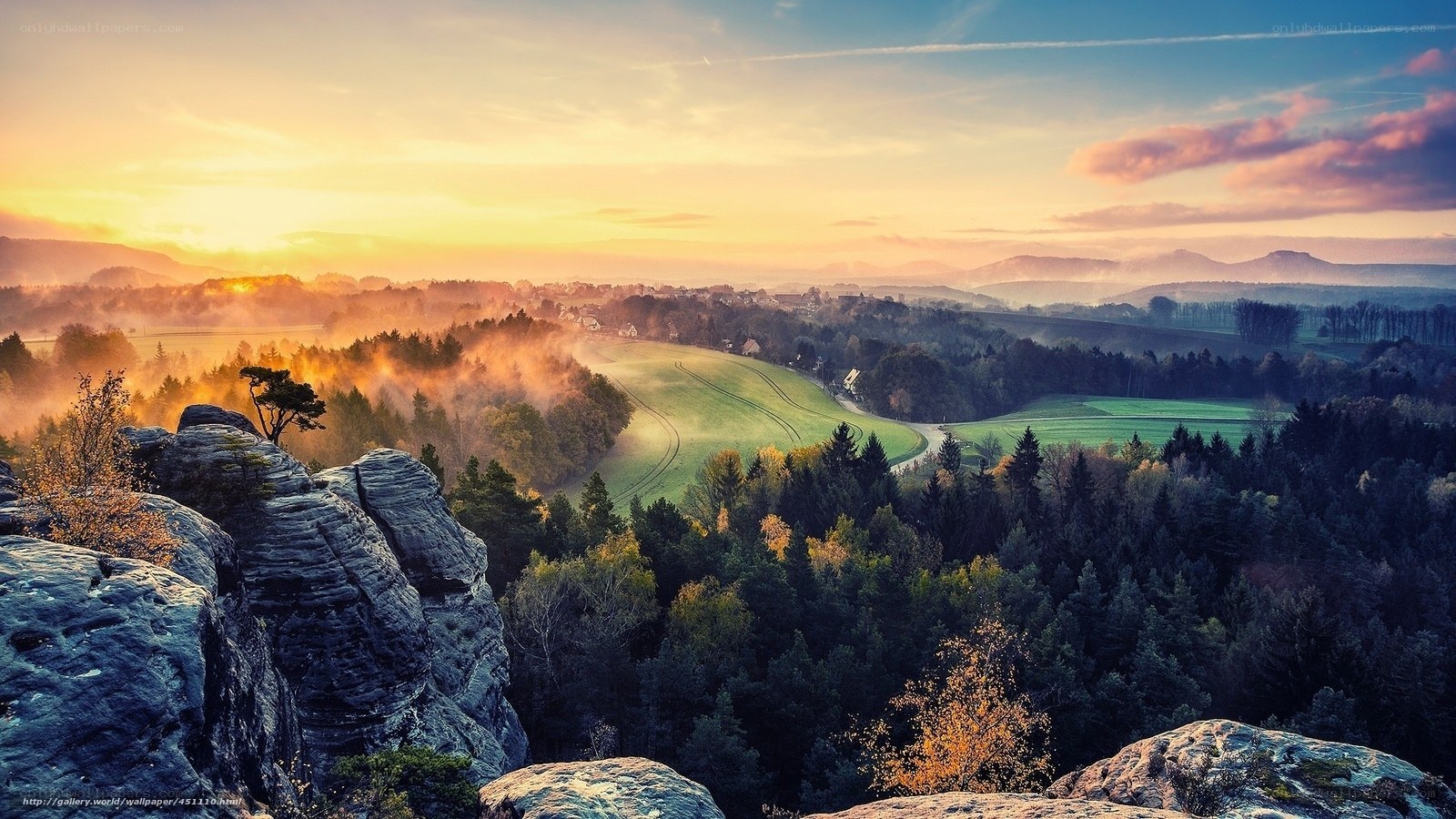 Sunrise over misty valley