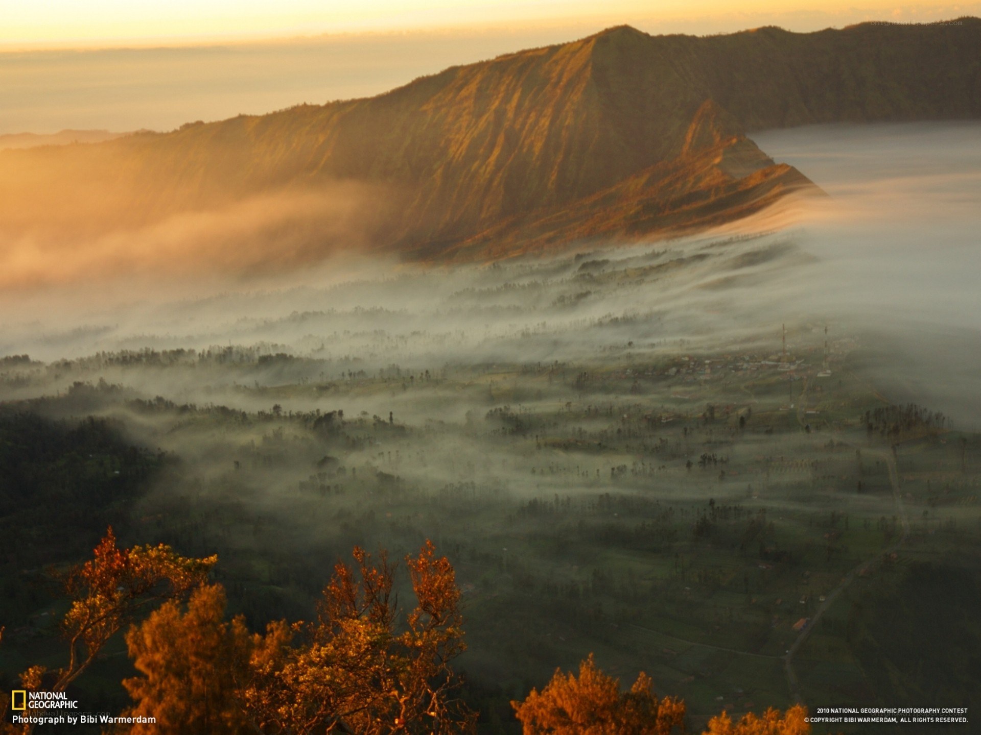 Sunrise over misty volcanic valley