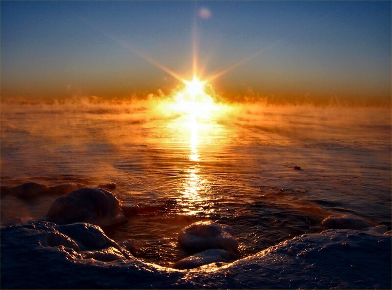 Sunrise over misty water