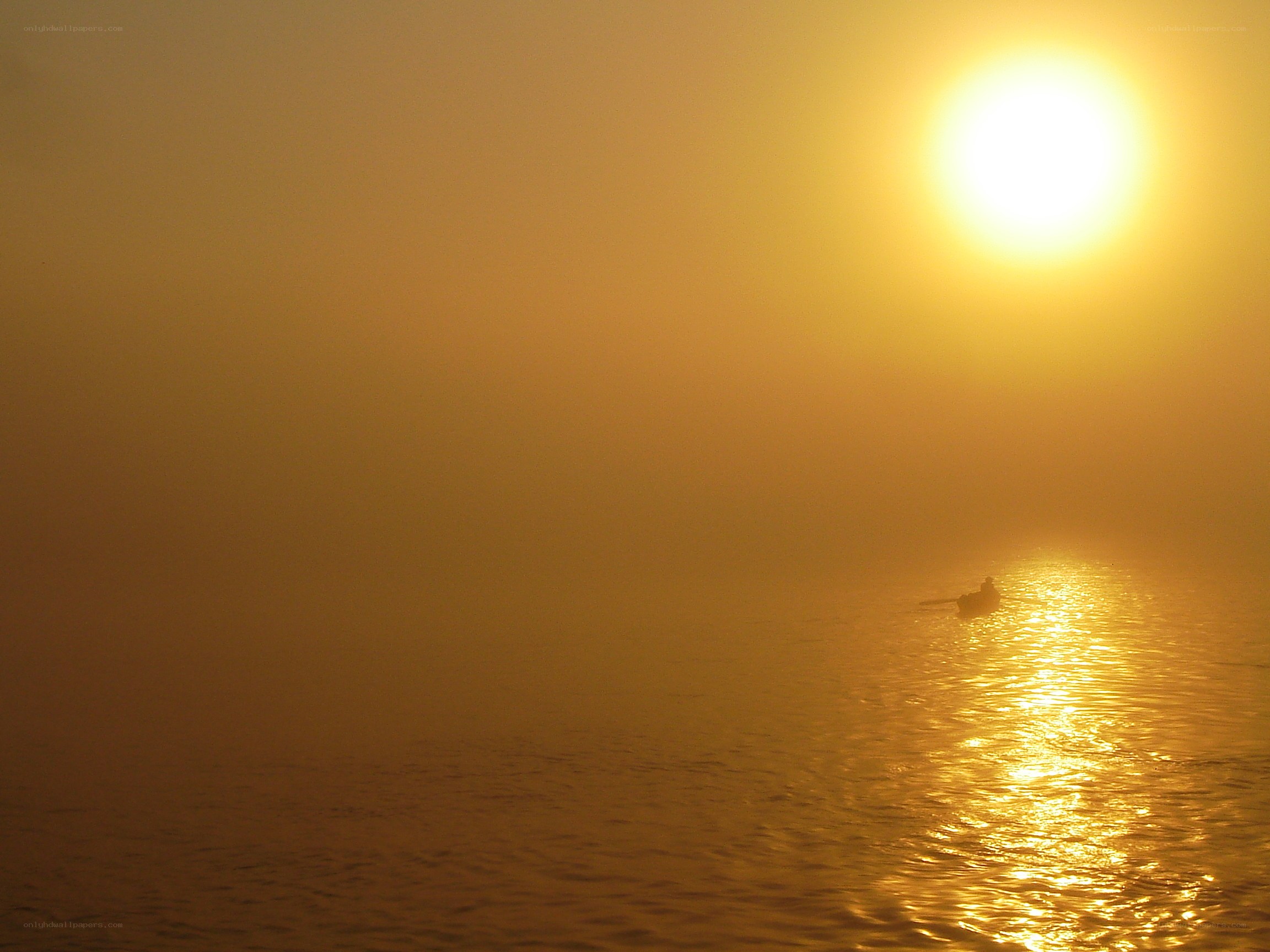 Sunrise over misty water