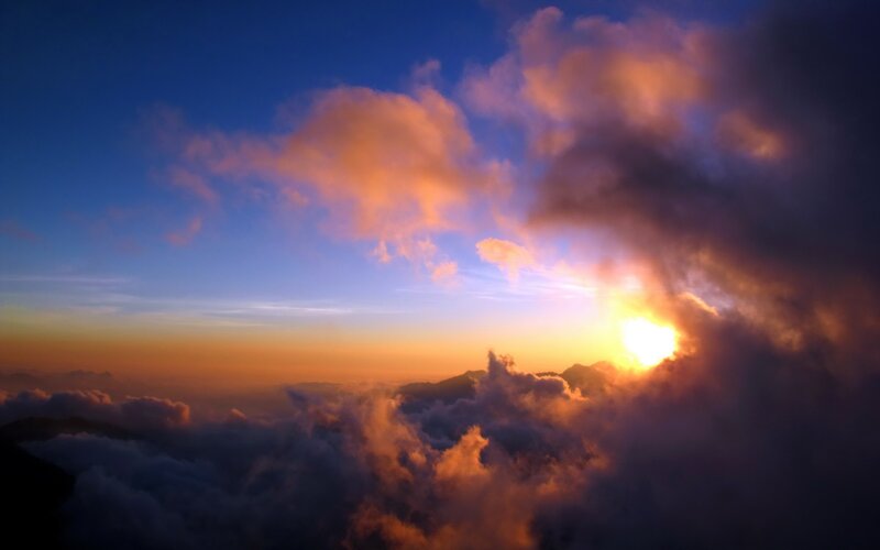 Sunrise over mountain clouds