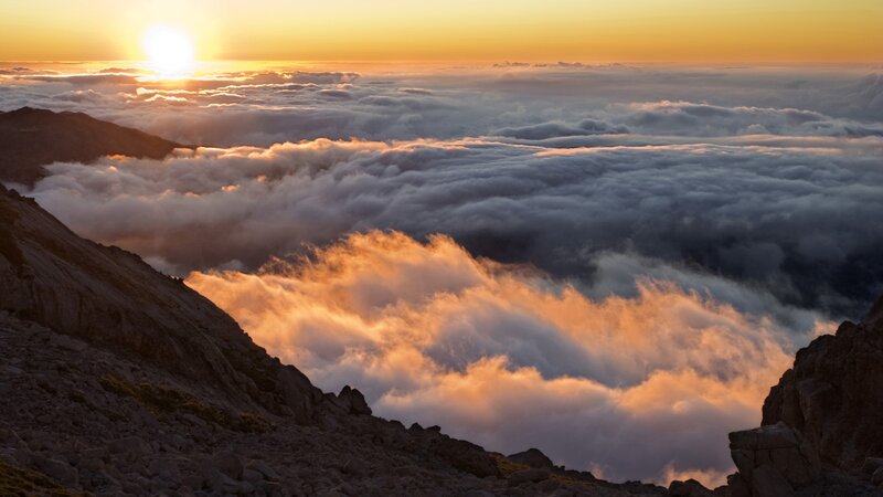Sunrise over mountain clouds