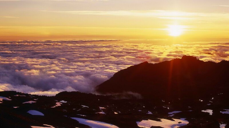 Sunrise over mountain clouds