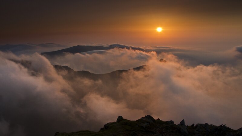 Sunrise over mountain clouds