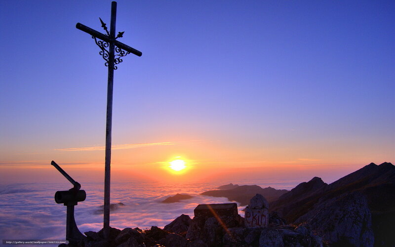 Sunrise over mountain cross