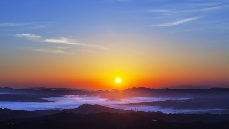 Sunrise over mountain fog