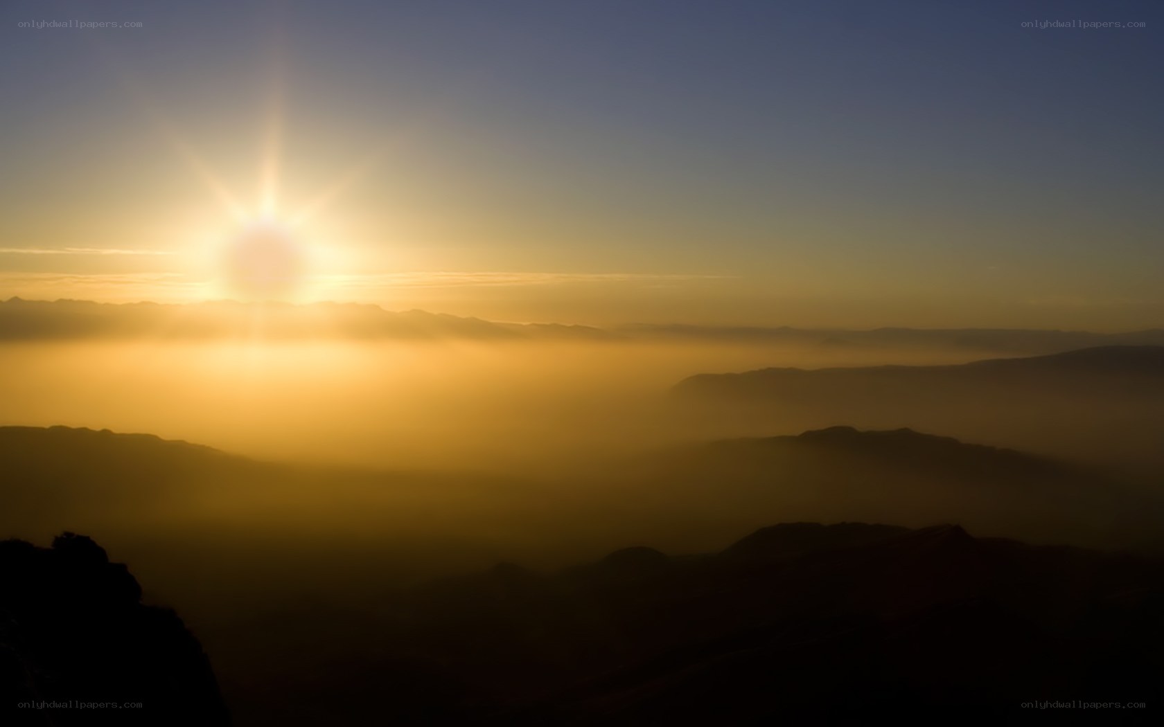Sunrise over mountain mist
