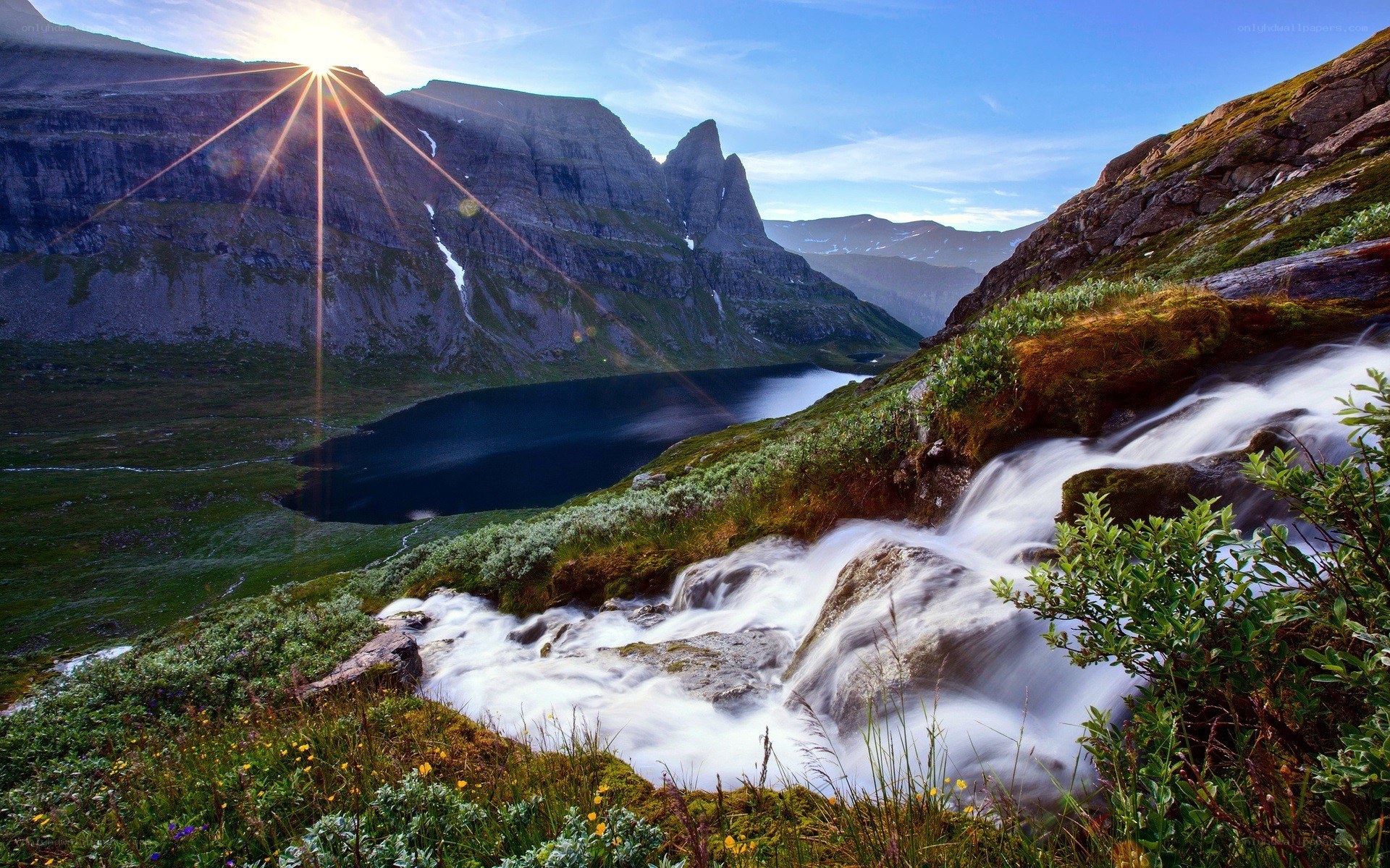 Sunrise over mountain waterfall