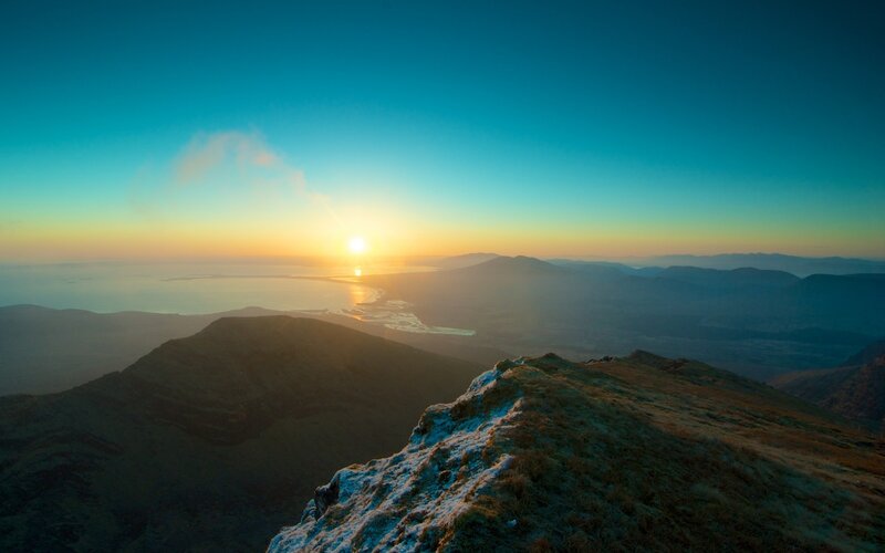 Sunrise over mountainous coastline
