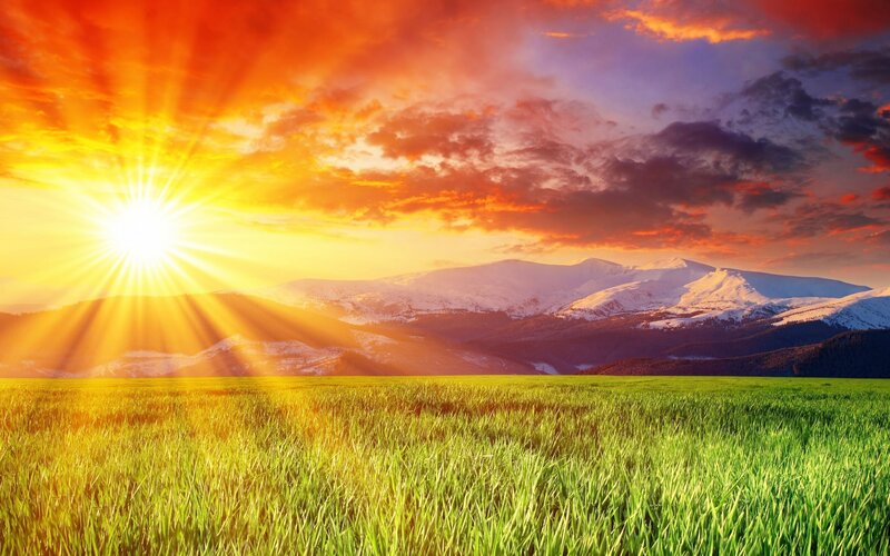 Sunrise over mountains and field