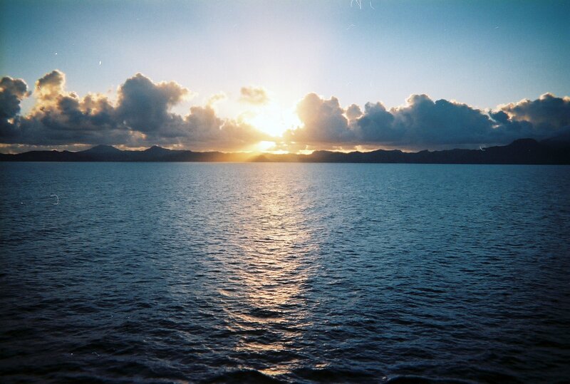 Sunrise over Ocean — Blue, Serene, Photograph, Clouds, Mountains