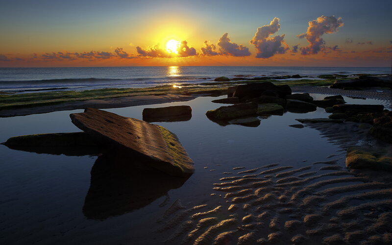 Sunrise over Rocky Beach — Orange, Serene