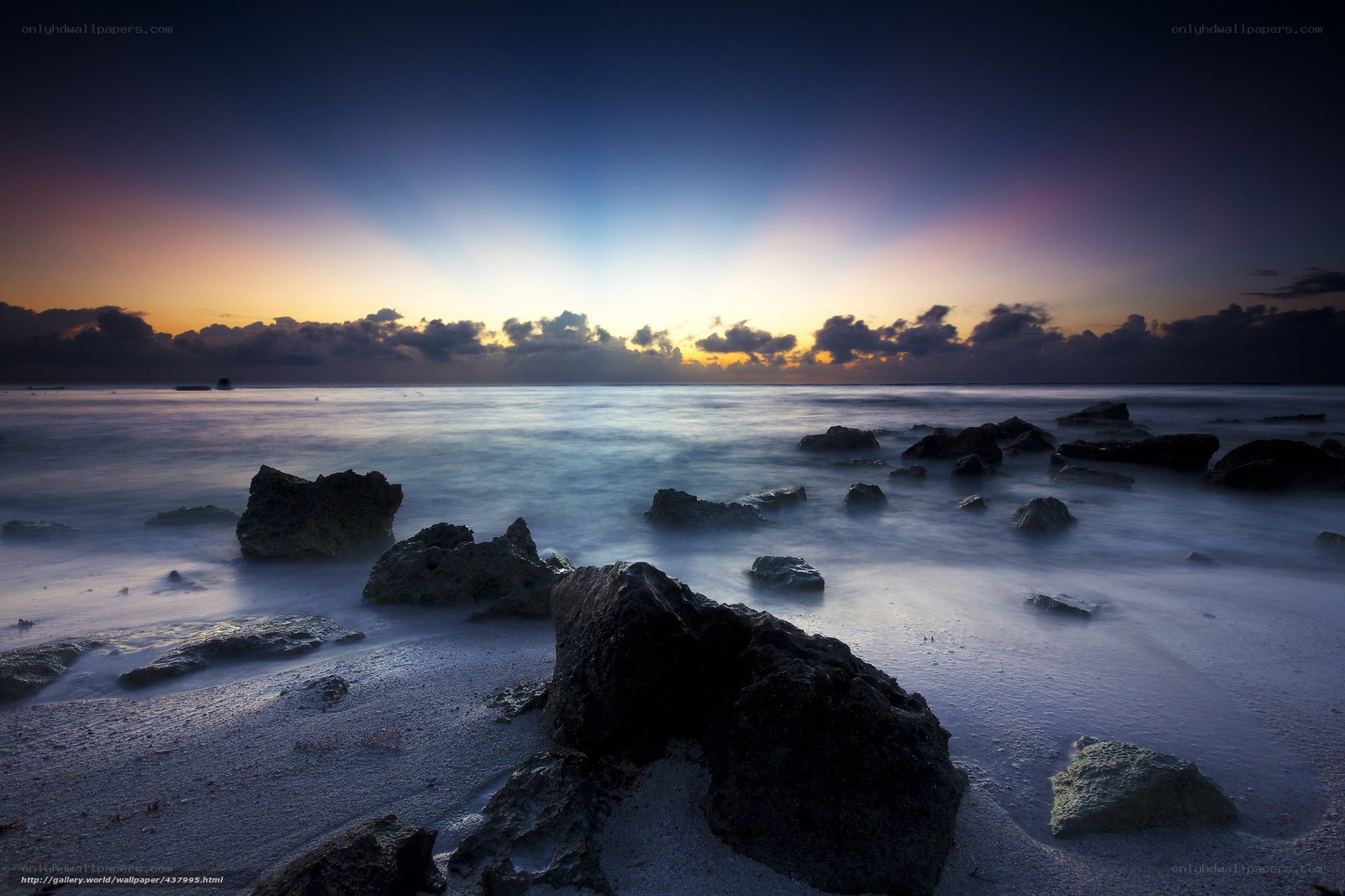 Sunrise over rocky beach