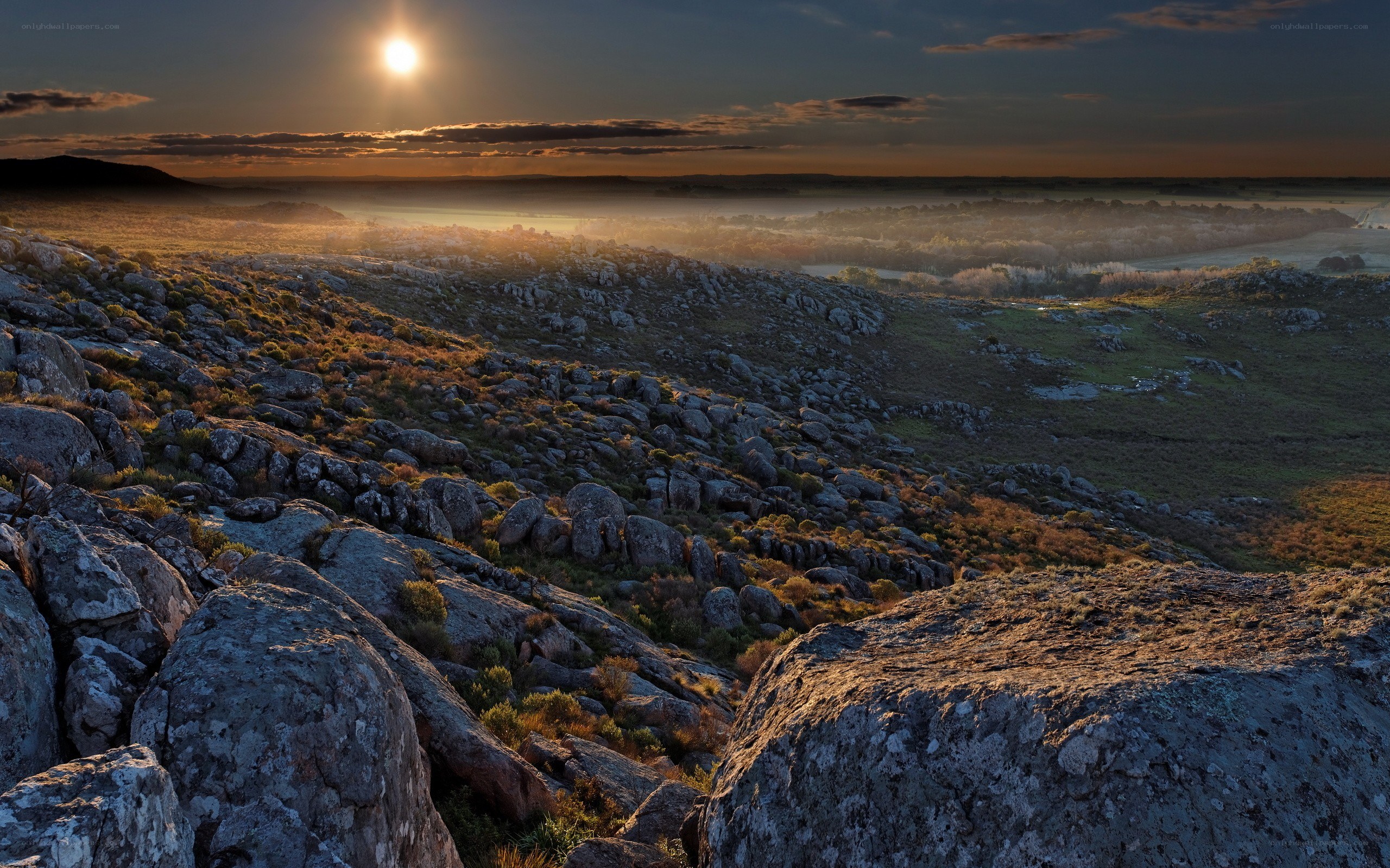 Sunrise over rocky hills