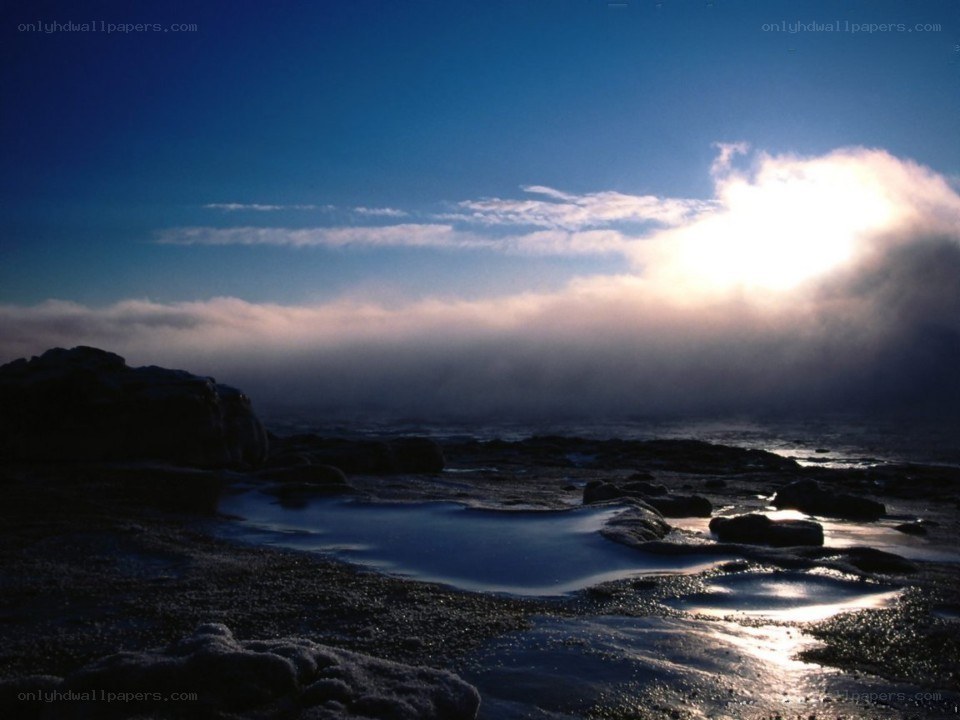 Sunrise over rocky shore