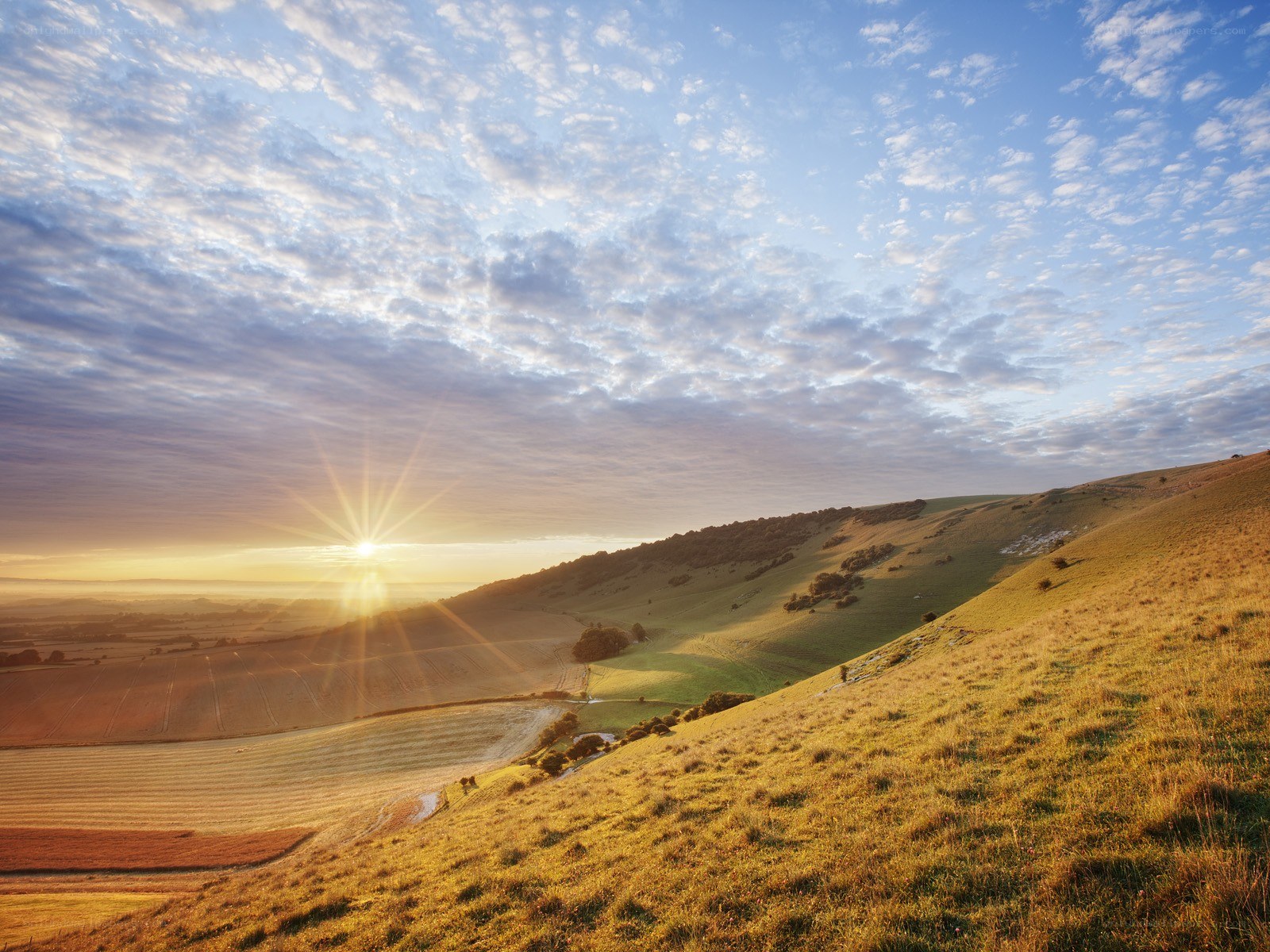Sunrise over rolling hills